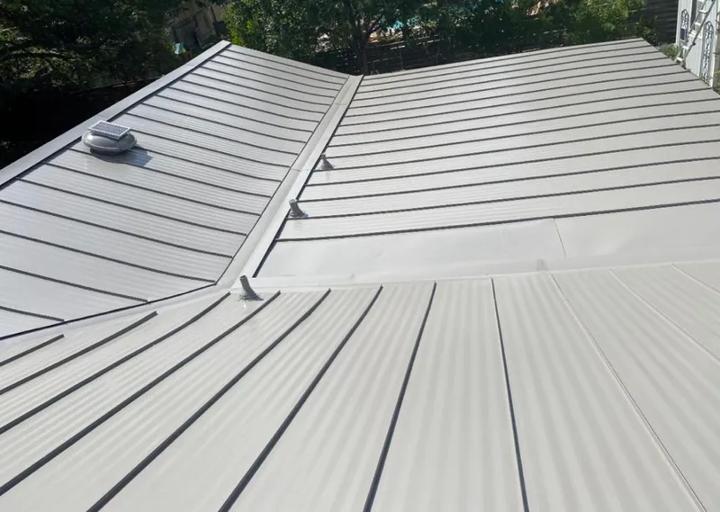 Solar attic fan installed on a metal roof for Roof Ventilation in Phenix City