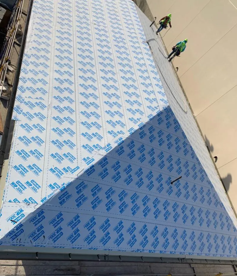 Professional roofers installing underlayment on a metal roof in Phenix City